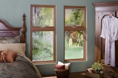 Two Elegant Looking Windows Side-By-Side Featuring A Wooden Frame
