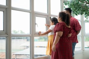 Family looking out large sunroom windows