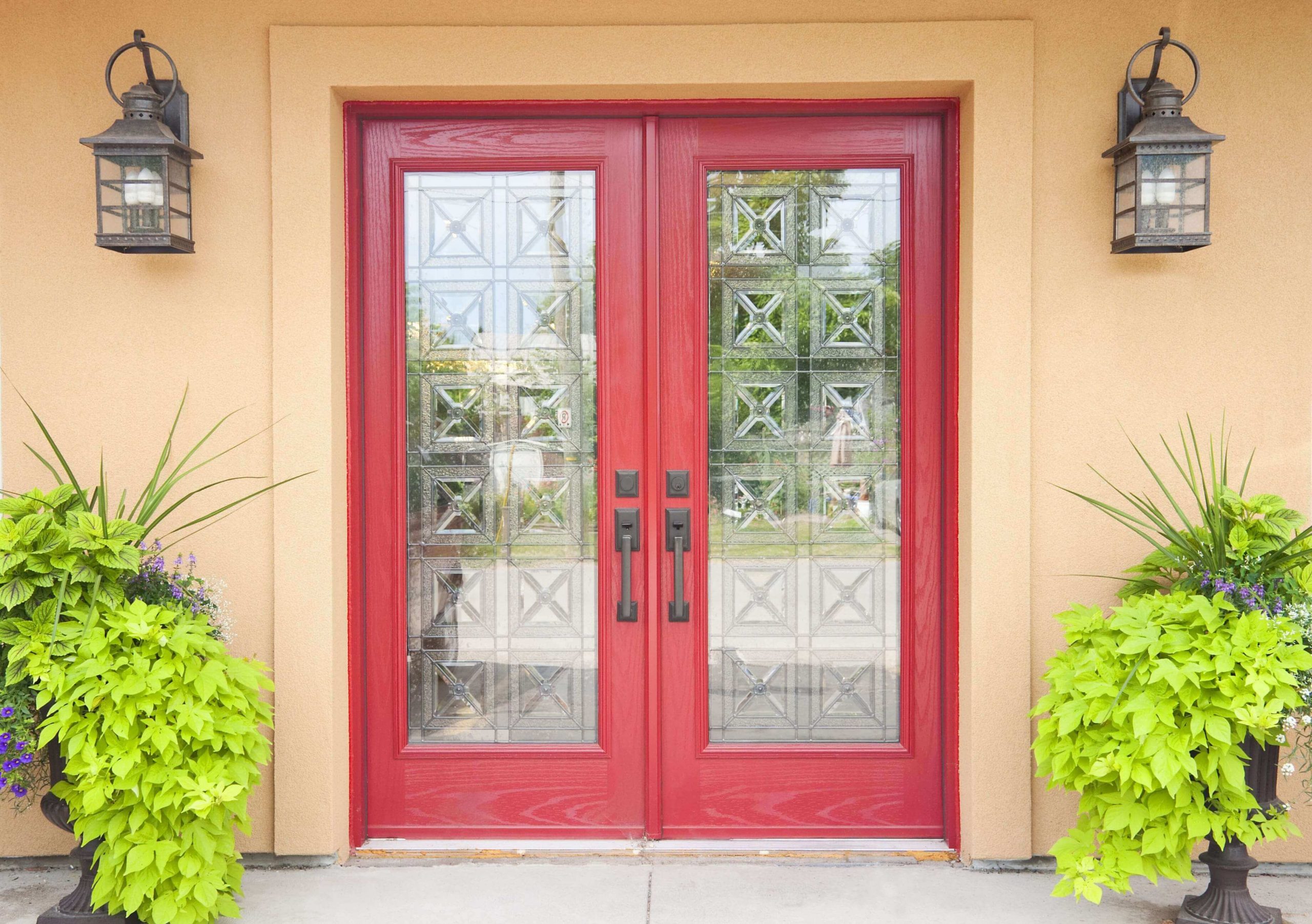 Home with red double front doors with decorative glass