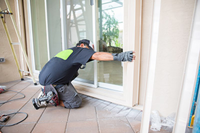 Worker crouching down to install new door