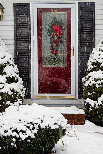 Home with storm door while snowing