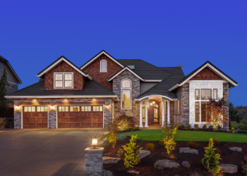 Outside view of luxury brick home with various picture windows