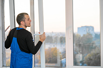 Professional window installer replacing outdated window for customer