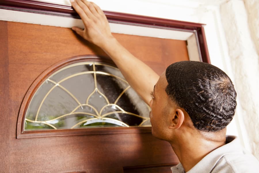 Door installer inspecting an entry door