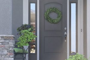 gray front door with wreath and planters