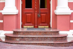 Three marble stairs with red door